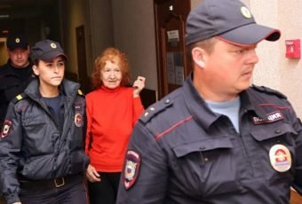Ripper Granny is escorted by guards to the courtroom